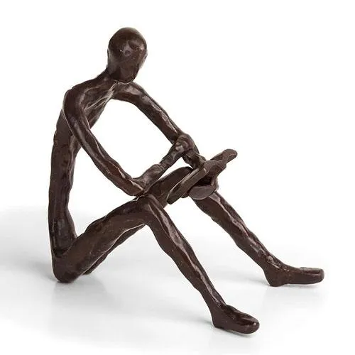 bronze man reading sculpture 